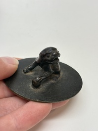 A Chinese bronze teapot and cover with a lion-shaped finial, Yuan