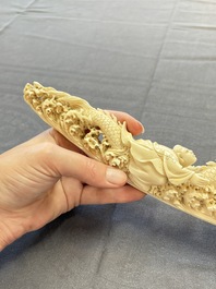 A Chinese ivory carving depicting a Luohan and a dragon, 'Da Ming 大明' mark, 19/20th C.