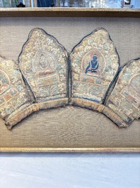 A framed Tibetan silk-embroidered four-leaf ritual crown with Transcendent Buddhas, 18th C.
