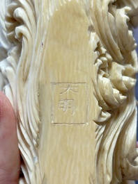 A Chinese ivory carving depicting a Luohan and a dragon, 'Da Ming 大明' mark, 19/20th C.