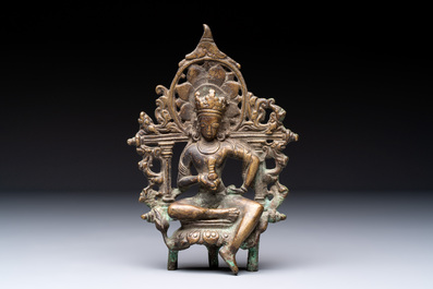 A Tibetan or Nepalese bronze seated Tara holding a vajra, 12/13th C.