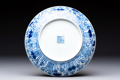 A Chinese blue and white 'lotus pond' plate, Qianlong mark, 19/20th C.
