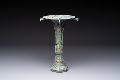 A Chinese archaic bronze wine vessel with 'taotie' design, 'gu 觚', Shang