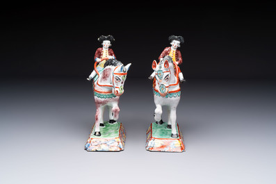 A pair of polychrome Dutch Delft petit feu models of horses with riders, 18th C.
