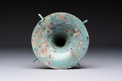 A Chinese archaic bronze wine vessel with 'taotie' design, 'gu 觚', Shang