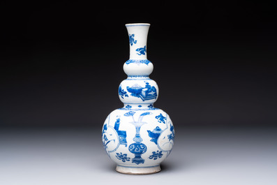 A Chinese blue and white double gourd 'Antiquities' vase, Kangxi