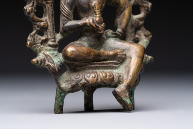 A Tibetan or Nepalese bronze seated Tara holding a vajra, 12/13th C.