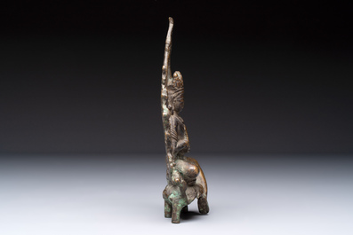 A Tibetan or Nepalese bronze seated Tara holding a vajra, 12/13th C.