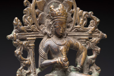 A Tibetan or Nepalese bronze seated Tara holding a vajra, 12/13th C.