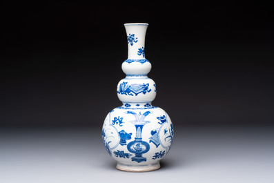 A Chinese blue and white double gourd 'Antiquities' vase, Kangxi