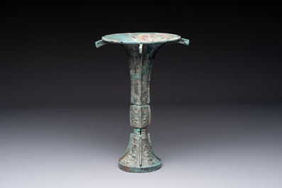 A Chinese archaic bronze wine vessel with 'taotie' design, 'gu 觚', Shang