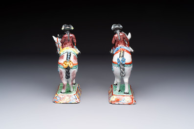 A pair of polychrome Dutch Delft petit feu models of horses with riders, 18th C.