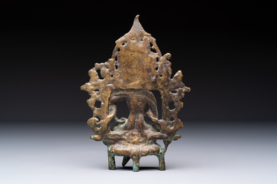 A Tibetan or Nepalese bronze seated Tara holding a vajra, 12/13th C.