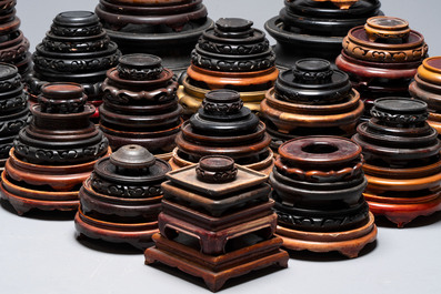 A large collection of 100 Chinese wooden stands, 19/20th C.