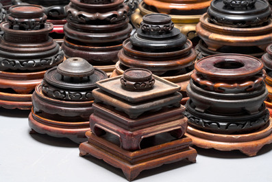 A large collection of 100 Chinese wooden stands, 19/20th C.