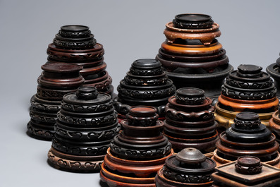A large collection of 100 Chinese wooden stands, 19/20th C.