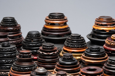 A large collection of 100 Chinese wooden stands, 19/20th C.