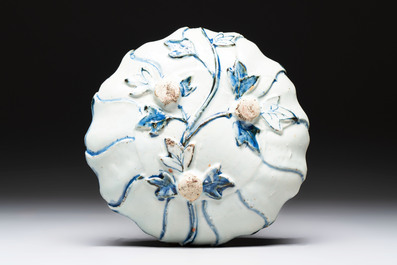 A Chinese blue and white ko-sometsuke flower-shaped tripod 'landscape' plate for the Japanese market, late Ming