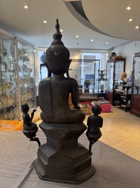 A large and fine Burmese bronze Buddha with two servants, 16/17th C.