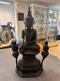 A large and fine Burmese bronze Buddha with two servants, 16/17th C.