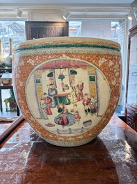 A large Chinese famille rose coral-red-ground fish bowl with narrative design, 19th C.