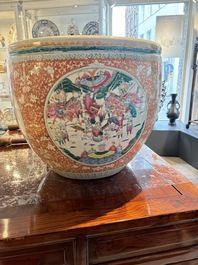 A large Chinese famille rose coral-red-ground fish bowl with narrative design, 19th C.