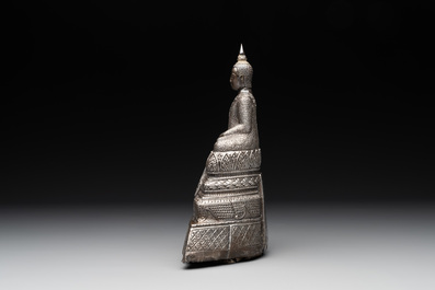 A Cambodian silver repouss&eacute; Buddha with inscription, 19th C.