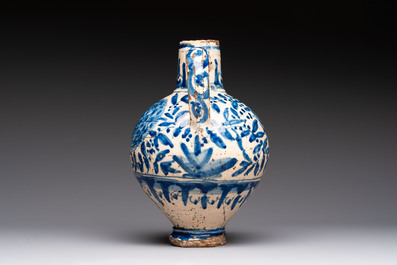 A blue and white Portugese faience jug with a bird among flowering branches, 17th C.