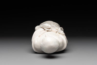Two Chinese Dehua blanc de Chine wine cups and a figure of Liuhai, 18/19th C.