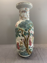 A pair of Chinese famille rose '18 Luohan' vases with relief design, 19th C.