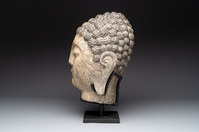 A large Chinese carved stone head of Buddha with traces of gilding and polychromy, Ming