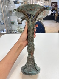A Chinese archaic bronze wine vessel with 'taotie' design, 'gu 觚', Shang