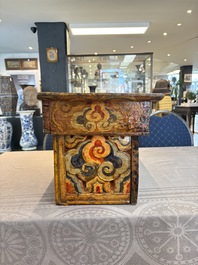 Two Tibetan polychromed wooden folding tables with dragon design, 19/20th C.