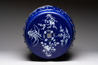 A Chinese white-slip-decorated blue-ground garden seat with floral design, 19th C.