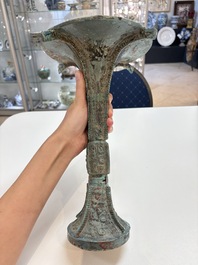 A Chinese archaic bronze wine vessel with 'taotie' design, 'gu 觚', Shang