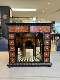 A small tortoiseshell-veneered cabinet of drawers with mirrored interior, Antwerp, 17th C.