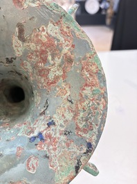 A Chinese archaic bronze wine vessel with 'taotie' design, 'gu 觚', Shang