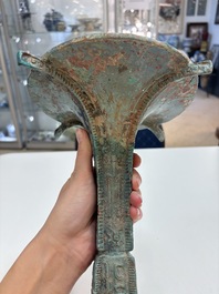A Chinese archaic bronze wine vessel with 'taotie' design, 'gu 觚', Shang