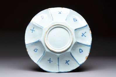 A blue and white Dutch Delft dish with a Chinese 'Gu' vase and a flower basket, 17th C.