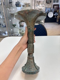 A Chinese archaic bronze wine vessel with 'taotie' design, 'gu 觚', Shang