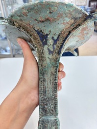 A Chinese archaic bronze wine vessel with 'taotie' design, 'gu 觚', Shang