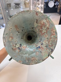 A Chinese archaic bronze wine vessel with 'taotie' design, 'gu 觚', Shang