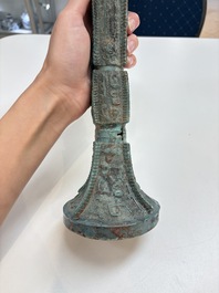 A Chinese archaic bronze wine vessel with 'taotie' design, 'gu 觚', Shang