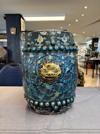 A Chinese Fahua barrel-shaped 'lotus scroll' stool with incised design, Ming