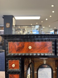 A small tortoiseshell-veneered cabinet of drawers with mirrored interior, Antwerp, 17th C.