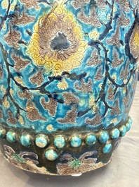 A Chinese Fahua barrel-shaped 'lotus scroll' stool with incised design, Ming