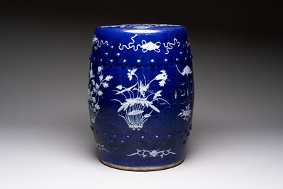 A Chinese white-slip-decorated blue-ground garden seat with floral design, 19th C.
