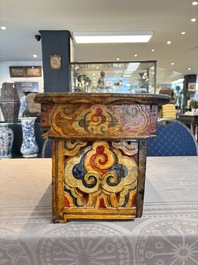 Two Tibetan polychromed wooden folding tables with dragon design, 19/20th C.