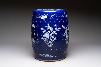 A Chinese white-slip-decorated blue-ground garden seat with floral design, 19th C.