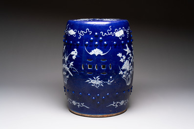 A Chinese white-slip-decorated blue-ground garden seat with floral design, 19th C.